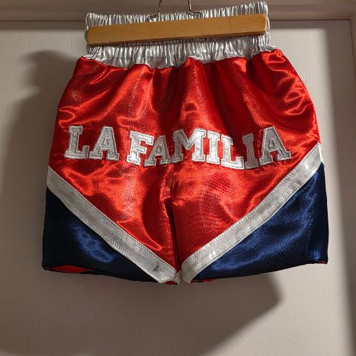 Completed red and blue boxing shorts with embroidered La Familia lettering