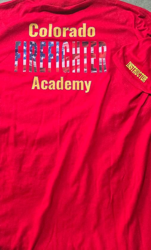 Completed red Colorado Firefighter Academy instructor shirt with a large back DTF graphic and instructor sleeve decoration