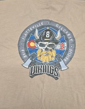 Completed tan Platteville-Gilcrest Fire Rescue Station 2 shirt with a Vikings department design