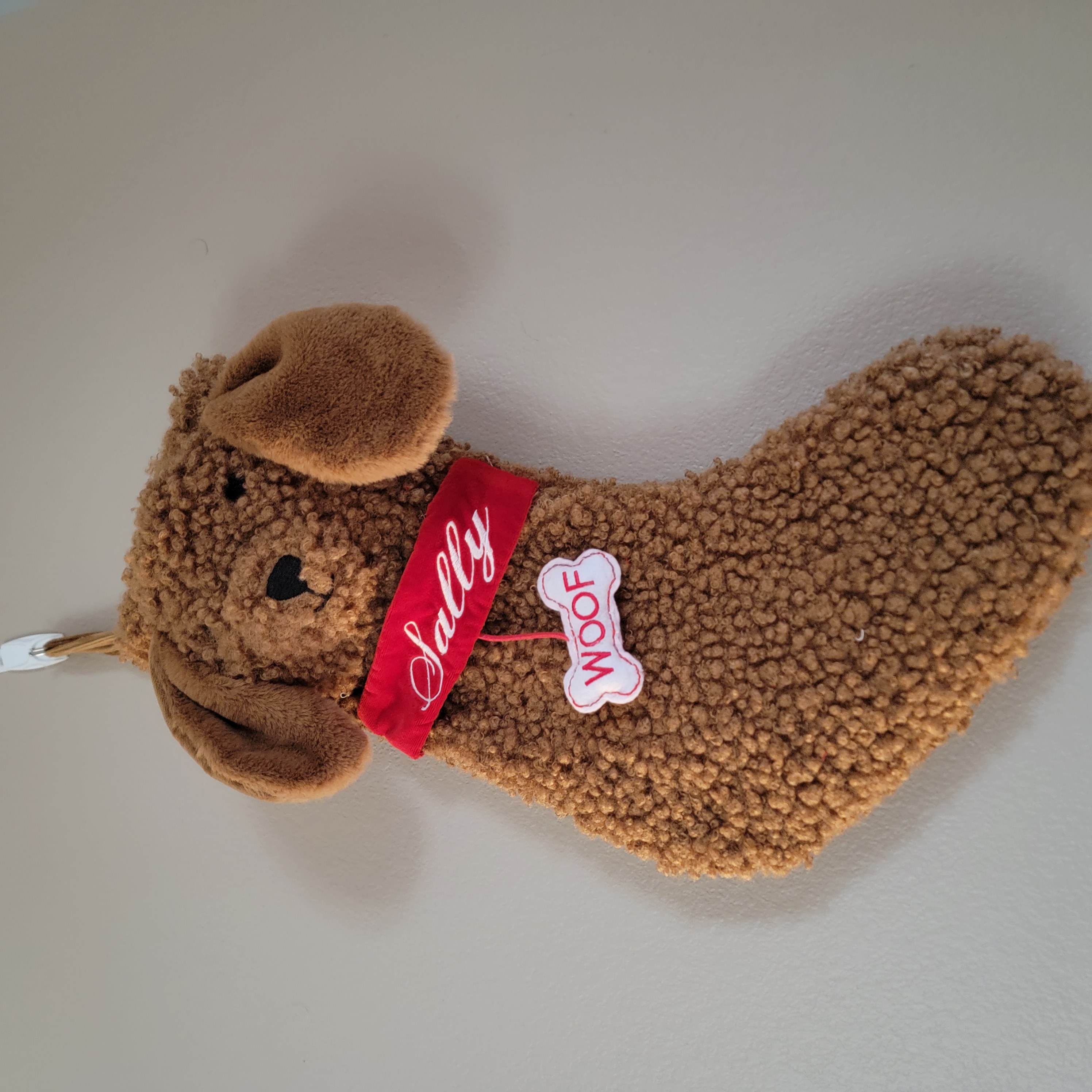 Completed personalized dog stocking with embroidered name and details