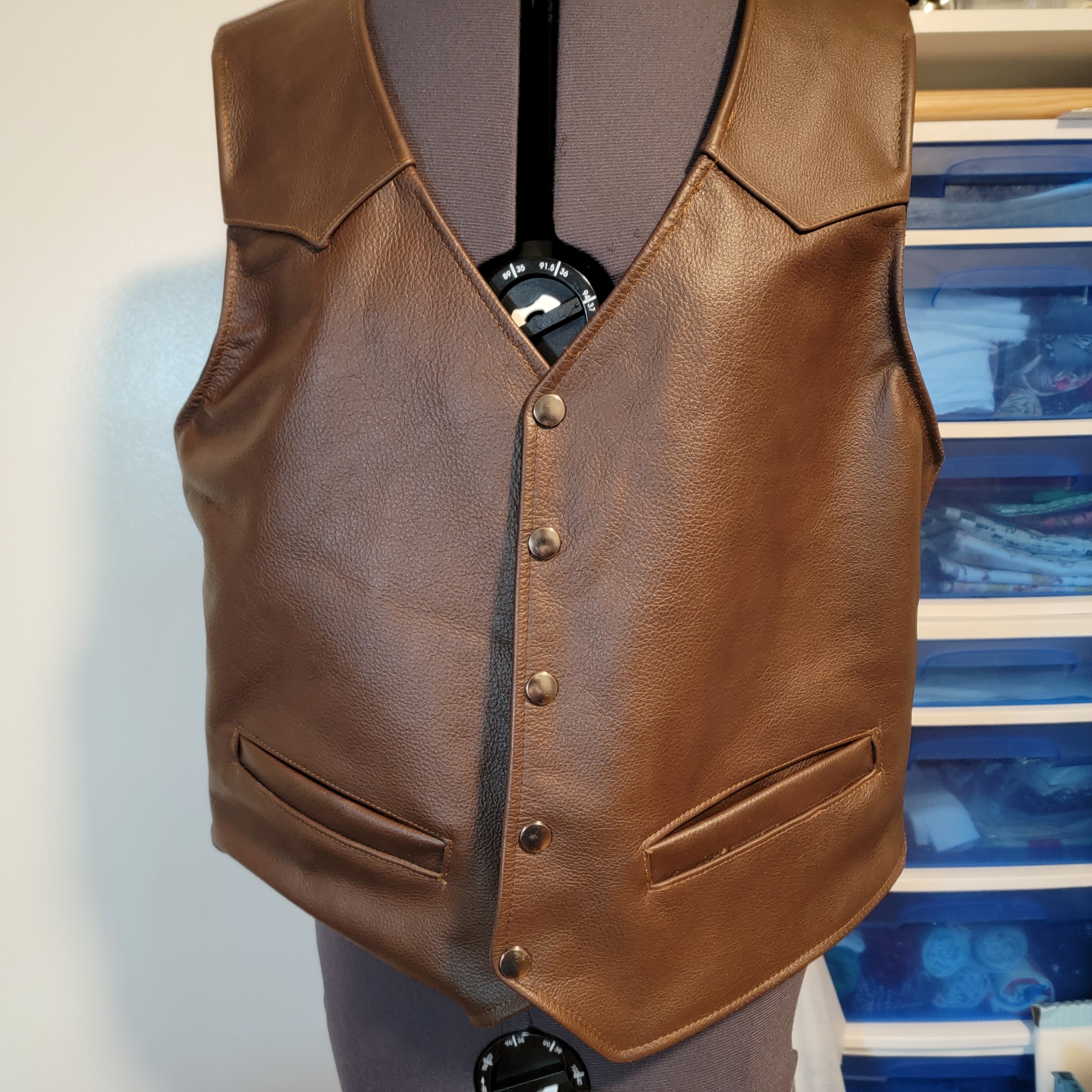 Closer view of custom leather vest construction and snap closure details