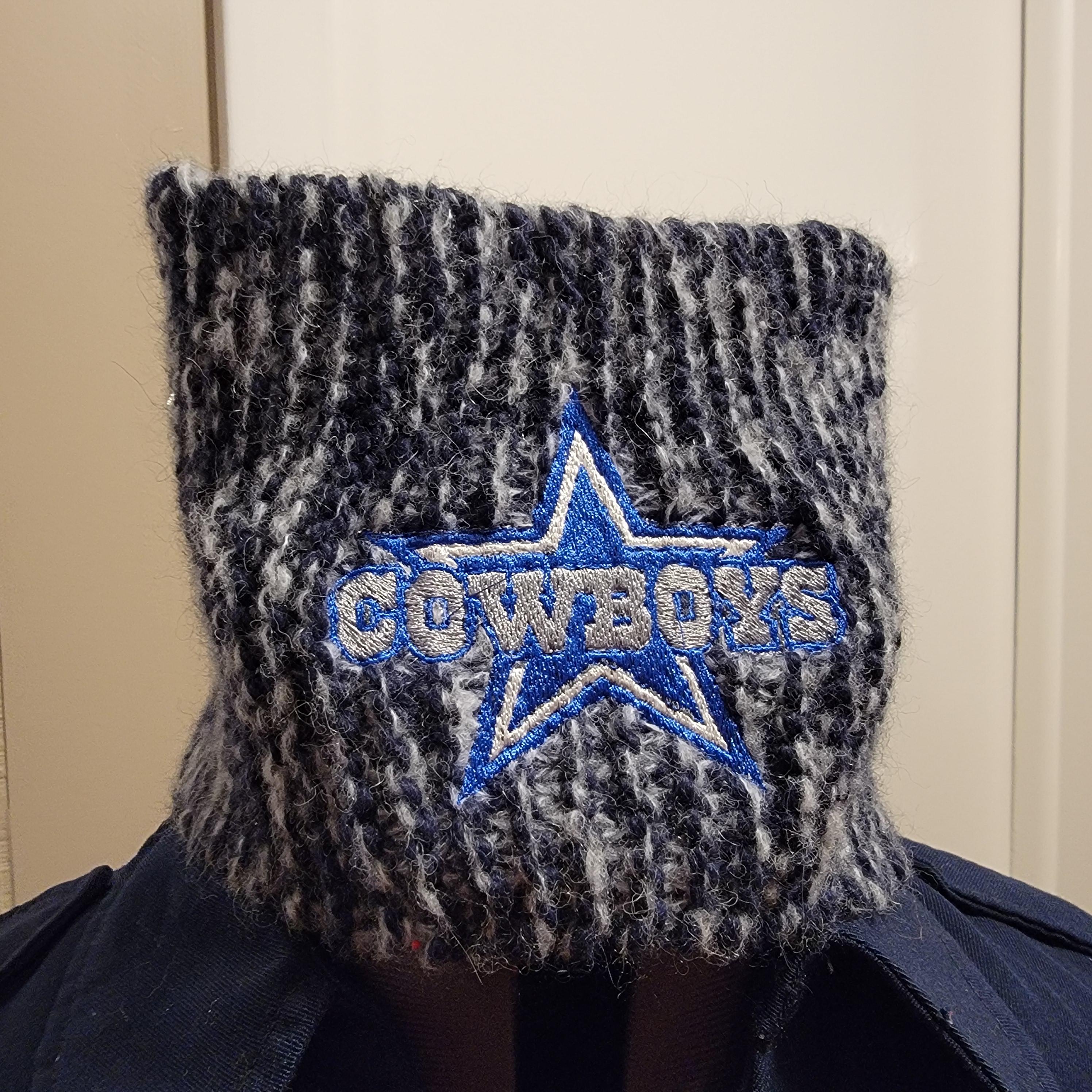 Detailed football-themed embroidery applied to a knitted item